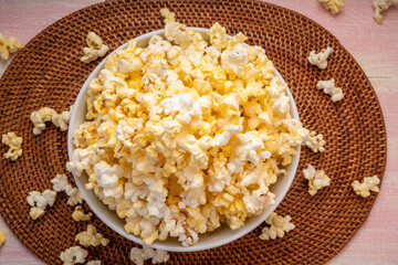 Popcorn in bown on wooden background. Popcorn in bowl on wooden table.