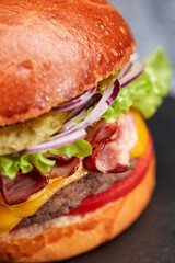 tasty burger with beef cutlet and vegetables