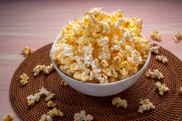 Popcorn in bown on wooden background. Popcorn in bowl on wooden table.