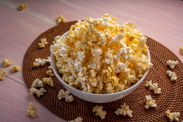 Popcorn in bown on wooden background. Popcorn in bowl on wooden table.
