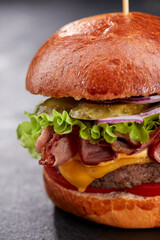 tasty burger with beef cutlet and vegetables