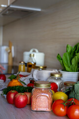 Young Asian woman takes out a glass jar of lentils from a grocery bag. Reusable package. Zero waste.