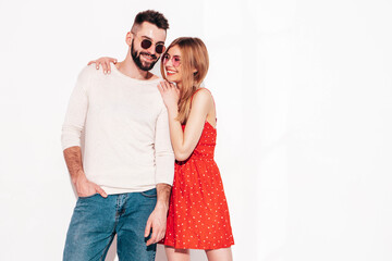 Sexy smiling beautiful woman and her handsome boyfriend. Happy cheerful family having tender moments near wall in studio.Pure cheerful models hugging.Embracing each other. Cheerful and happy