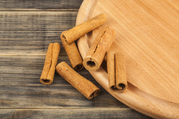 Cinnamon sticks on a wooden background.