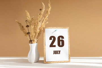 july 26. 26th day of month, calendar date.White vase with dried flowers on desktop in rays of sunlight on white-beige background. Concept of day of year, time planner, summer month