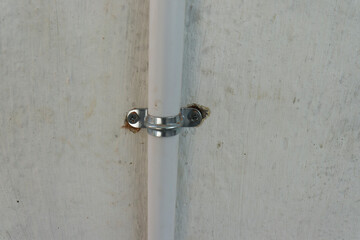 plastic pipe and clamp attached on the wall