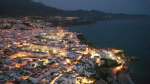 Scenic view from drone of spanish town of Nerja on southern Mediterranean coast at night, Malaga, Spain