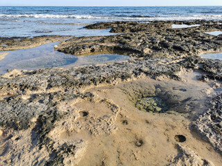 The coast of the Mediterranean Sea, long frozen lava, in the recesses of which there is sea water.