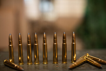 Sharp ammunition stands on a wooden box for the rifle.