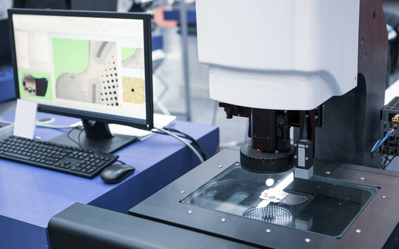 Vision measuring machine inspecting workpiece. Industrial manufacture