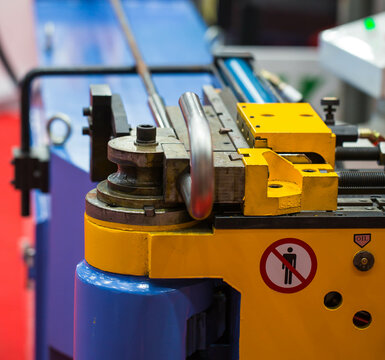 Automatic industrial round bender machine for metal wire rod and tube. Industrial metalwork machinery.	
