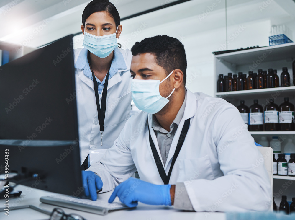 Poster Every contribution brings us closer to our goal. Shot of two young researchers using a computer in a laboratory.