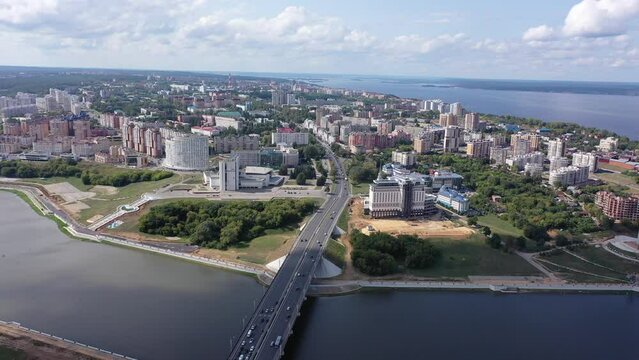 Scenic general aerial view of Cheboksary cityscape on banks of Volga River on sunny summer day, Chuvashia, Russia. High quality 4k footage