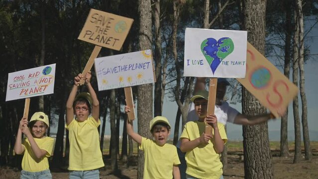 Group of activist children with posters protesting for the conservation of the planet.
