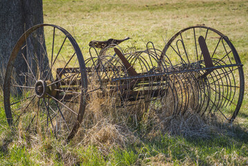 An ancient device designed to collect hay and driven by horses.