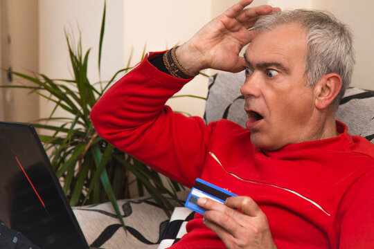 Angry Or Frustrated Man With Credit Card And Laptop Shopping Online