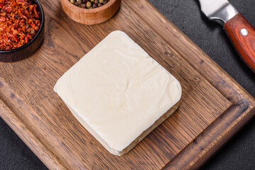 Image of a bar and grated mozzarella cheese on a dark background