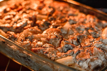 A delicious nutritious dish with meat, mushrooms, vegetables and potatoes, baked in a creamy sauce in an oven