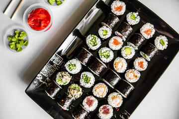Sushi set close-up on black background. Traditional Japanese seafood. Delicious roll. Advert for food delivery service. 