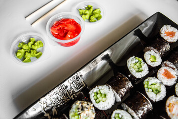 Sushi set close-up on black background. Traditional Japanese seafood. Delicious roll. Advert for food delivery service. 