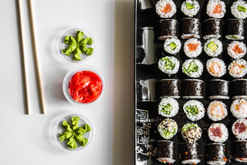 Sushi set close-up on black background. Traditional Japanese seafood. Delicious roll. Advert for food delivery service. 