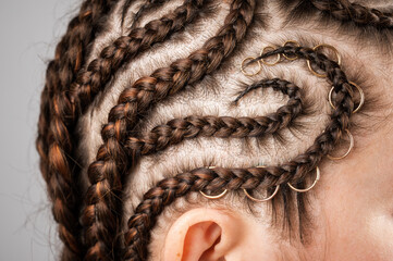 Close-up of braids on the head of a caucasian woman. - obrazy, fototapety, plakaty