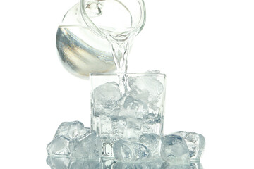 Female hand pour water in glass with ice, isolated on white background