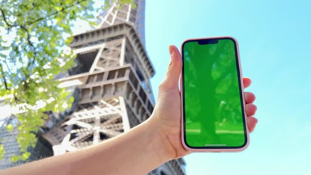 Teenage girl with loose hair brown hair brown hair dances with phone rejoices on the screen of lameness green screen beige background. High quality 4k footage