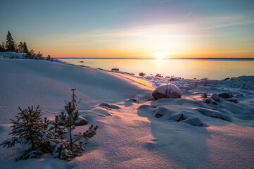 Panoramic sunset through the horizon. Winter wonderland scenery in scenic golden evening light at...