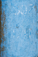 Faded blue painted sign on metal pole grunge texture