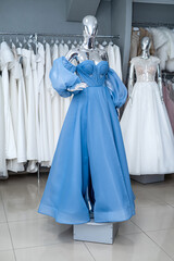 blue evening dress on mannequin for party bridesmaid wedding in bridal shop