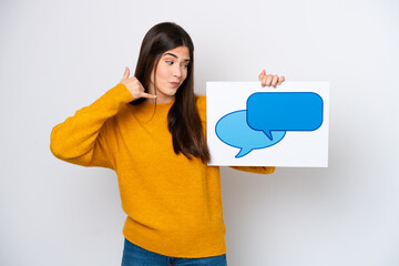 Young Brazilian woman isolated on white background holding a placard with speech bubble icon and doing phone gesture