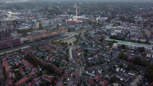 Aerial view arriving at fair showing several funfair attractions and wave swinger is amusement ride that is a variation on the carousel in which the seats are suspended from the rotating summit 4k