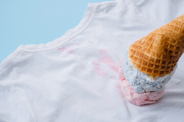 close up dirty stain ice cream on white clothes on a blue background. top view. daily life stain...