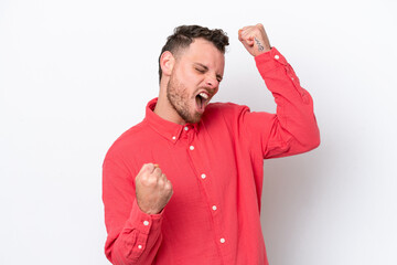 Young Brazilian man isolated on white background celebrating a victory