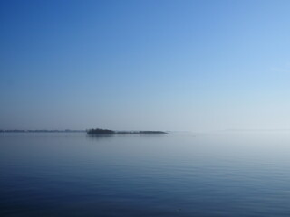 island in the fog on the Volga in spring