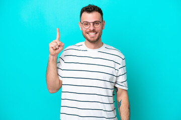 Fototapeta premium Young Brazilian man isolated on blue background pointing up a great idea
