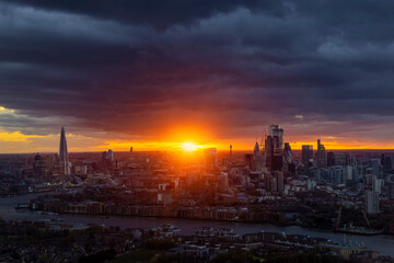 Wide, panoramic view of the 2022 skyline of London during a cloudy sunset with sunflare, England