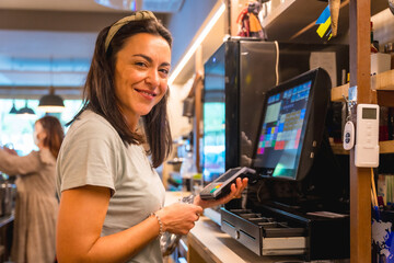 A waitress charging by card with the coffee shop