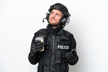 Brazilian soldier man isolated on white background holding coffee to take away and a mobile while thinking something