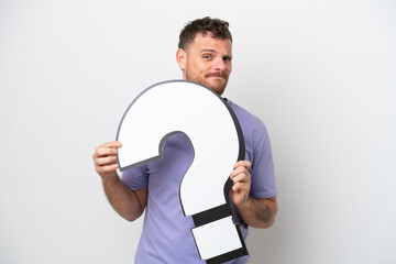 Young Brazilian man isolated on white background holding a question mark icon and with sad expression