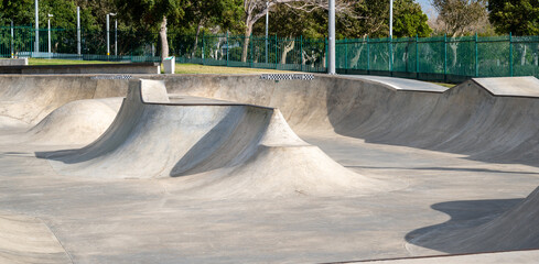 Public playground for a skateboard in a recreation park.