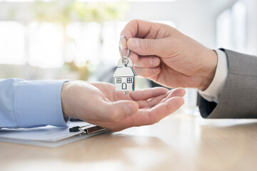 Real estate agent property realtor or landlord giving house keys