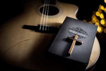 Holy Bible with guitar and religious crucifix cross, gospel music concept