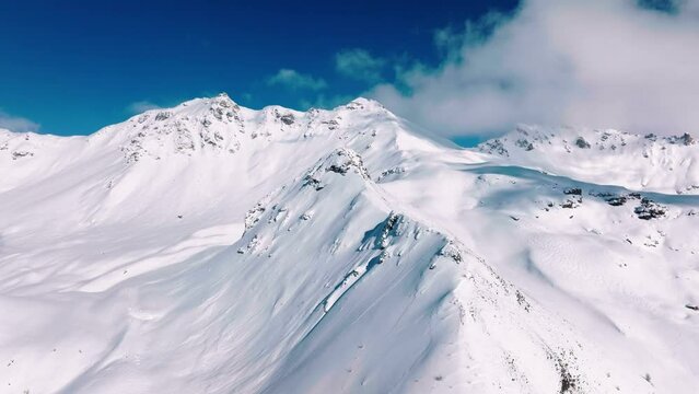 Flying over The Les Rechasses Towards Becca de Lovegno Mountain On A Cold Winter Day In Mont Noble, Val d'Herens Valley, Valais, Switzerland. - aerial