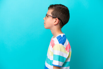 Little boy isolated on blue background With glasses
