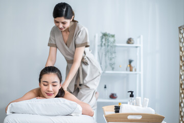 Asian young woman feeling happy and relax during back massage with oil