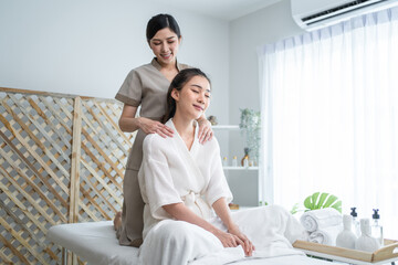 Asian young happy woman feeling relax during shoulder and back massage - obrazy, fototapety, plakaty