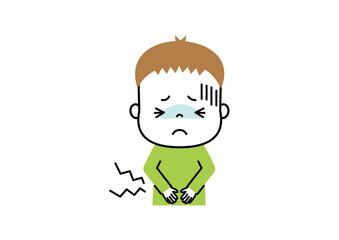お腹が痛くてお腹を押さえて苦しそうな表情をしている男の子
