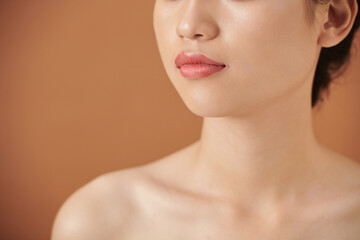 Cropped image of young woman with beautiful flawless skin and full lips